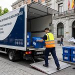 Operarios especializados de Elimina cargando contenedores de documentos confidenciales en vehículo geolocalizados para su destrucción certificada